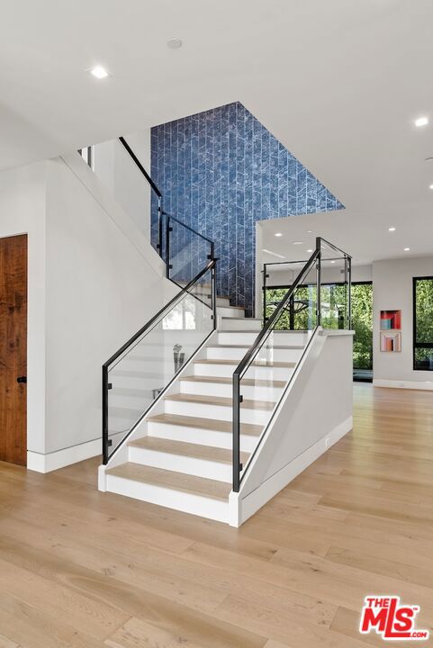 stairway with hardwood / wood-style floors