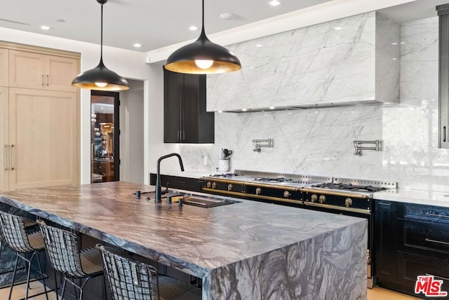 kitchen with pendant lighting, sink, and decorative backsplash