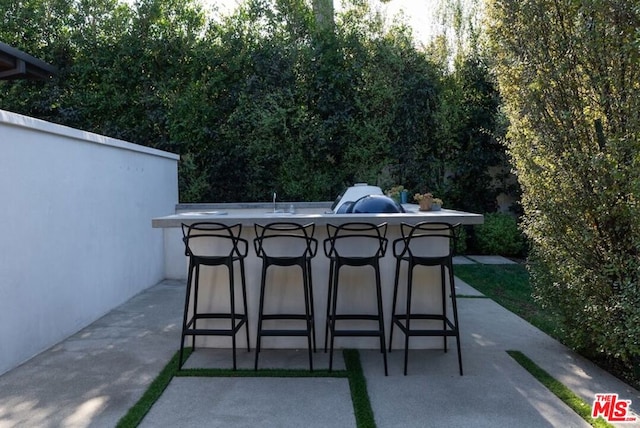 view of patio featuring a grill and an outdoor bar