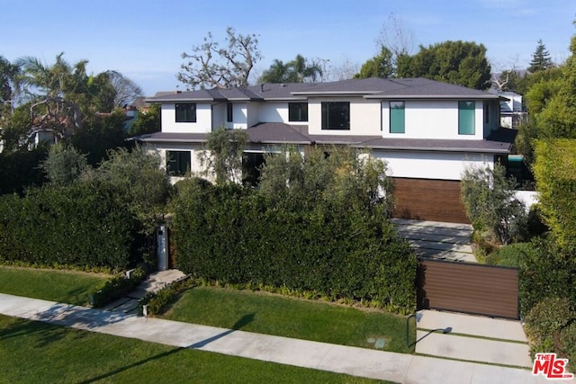 view of front facade with a garage and a front lawn