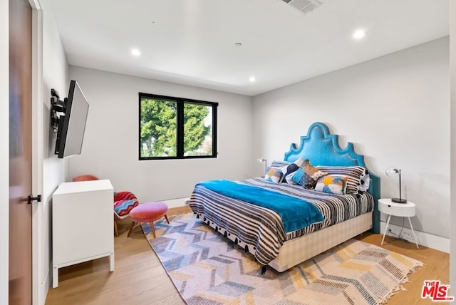 bedroom with light hardwood / wood-style flooring