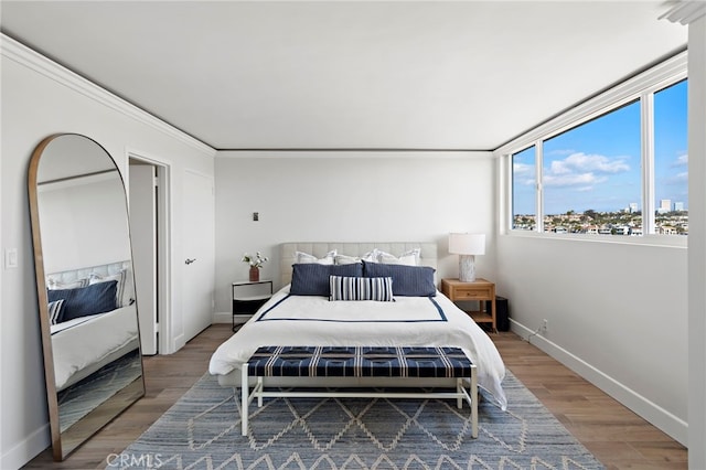 bedroom featuring baseboards and wood finished floors