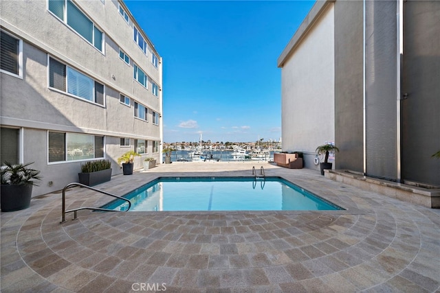 community pool with a patio area