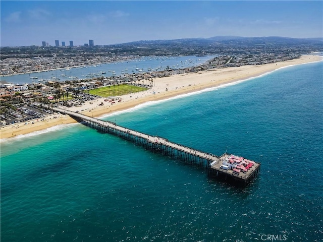 drone / aerial view featuring a view of the beach, a view of city, and a water view