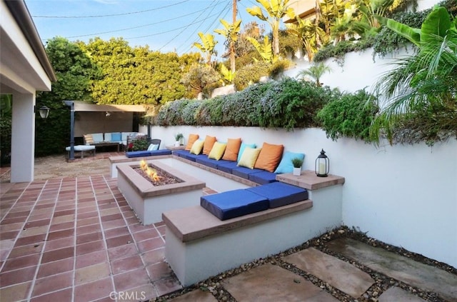 view of patio / terrace featuring an outdoor living space with a fire pit