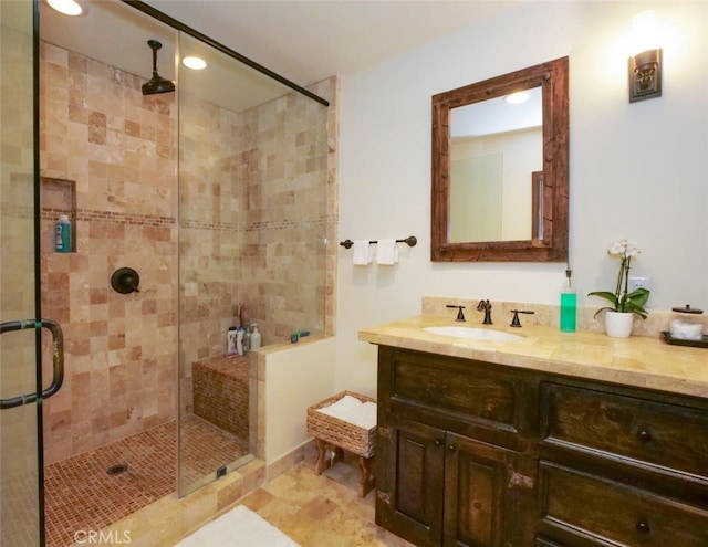 bathroom featuring vanity and a shower with door