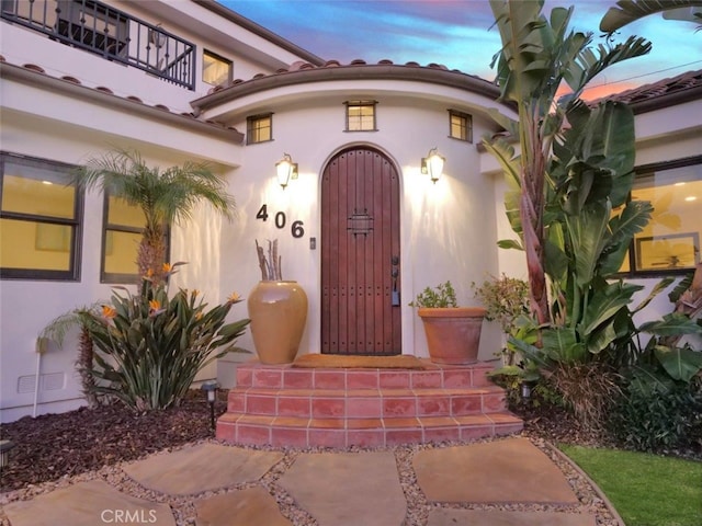 view of exterior entry at dusk