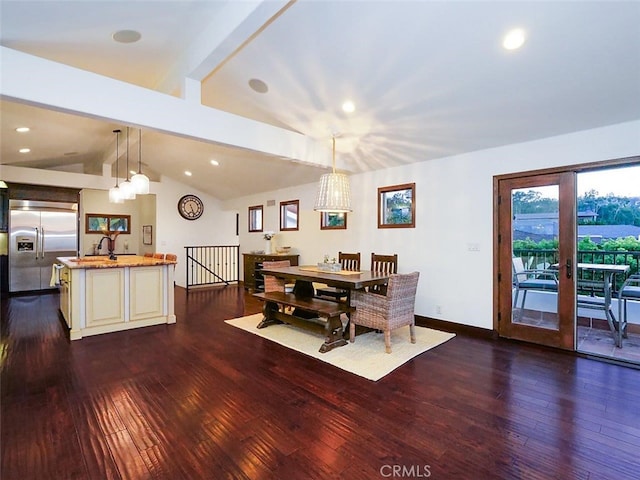 dining space featuring lofted ceiling, sink, dark hardwood / wood-style flooring, and french doors