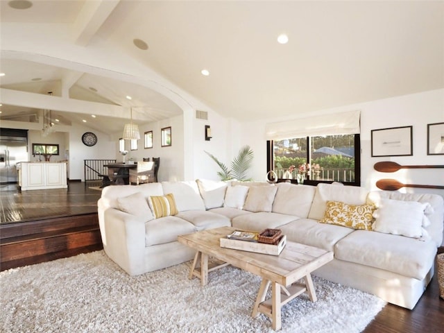 living room featuring dark hardwood / wood-style floors and vaulted ceiling with beams