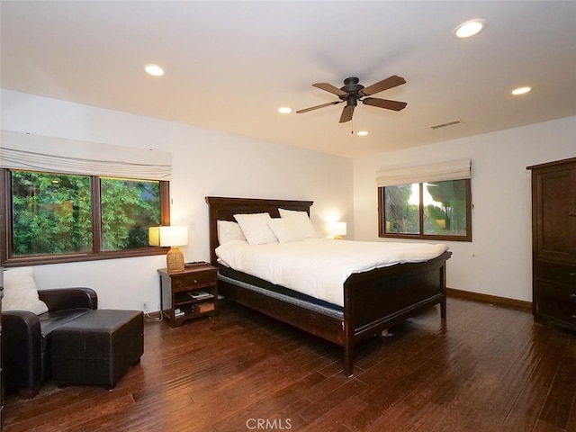 bedroom with ceiling fan and dark hardwood / wood-style flooring