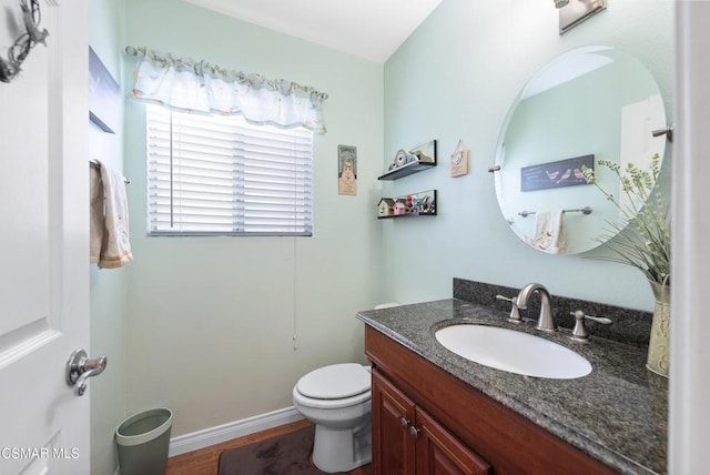 bathroom with vanity, wood-type flooring, and toilet