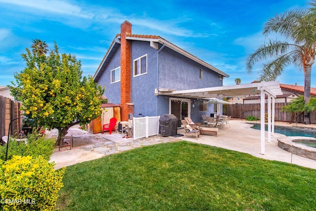 rear view of house featuring a swimming pool with hot tub, a pergola, a patio area, and a lawn