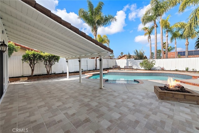 view of swimming pool with a patio area and an outdoor fire pit