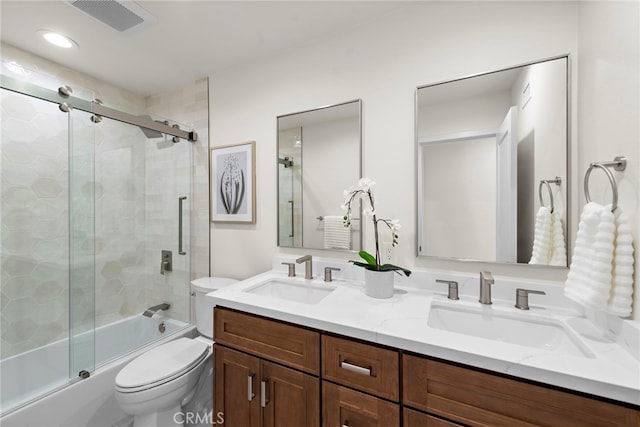 full bathroom featuring bath / shower combo with glass door, vanity, and toilet