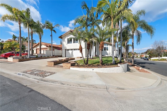 mediterranean / spanish-style home with a garage