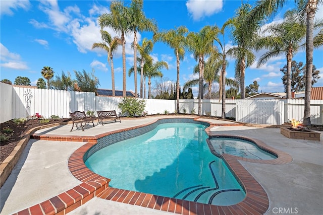 view of pool with a patio area and an in ground hot tub