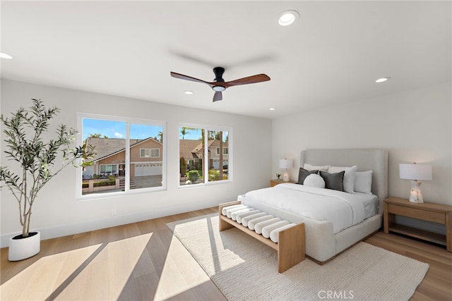 bedroom featuring ceiling fan and light hardwood / wood-style flooring