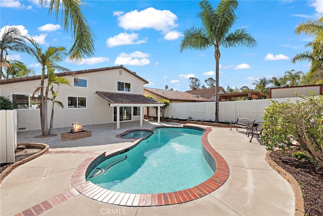 view of swimming pool with a patio area and a fire pit