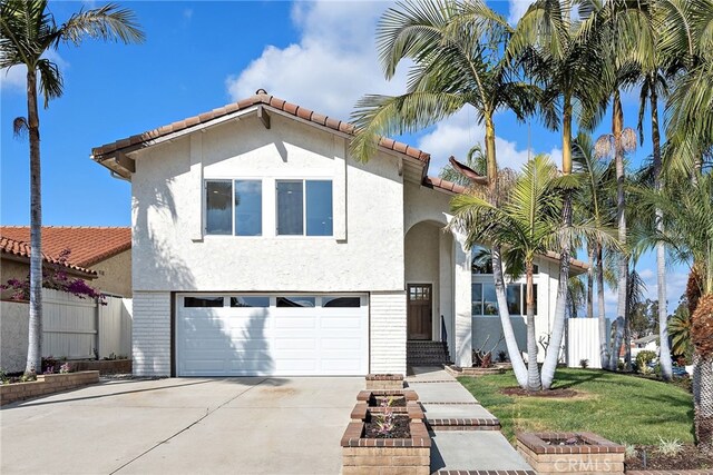 mediterranean / spanish home with a garage