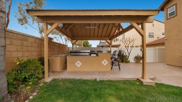 view of patio with exterior bar, a gazebo, and exterior kitchen