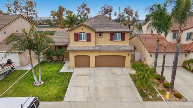 view of front of property with a garage and a front yard