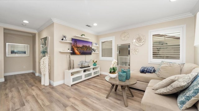 living room featuring crown molding and light hardwood / wood-style flooring