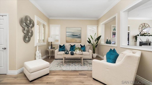 sitting room featuring wood-type flooring and ornamental molding