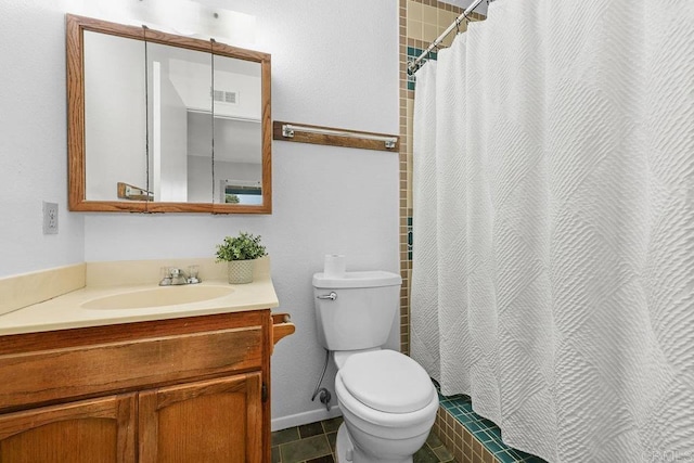 bathroom featuring vanity, tile patterned floors, toilet, and walk in shower