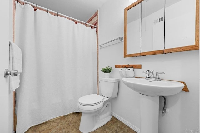 bathroom featuring sink and toilet