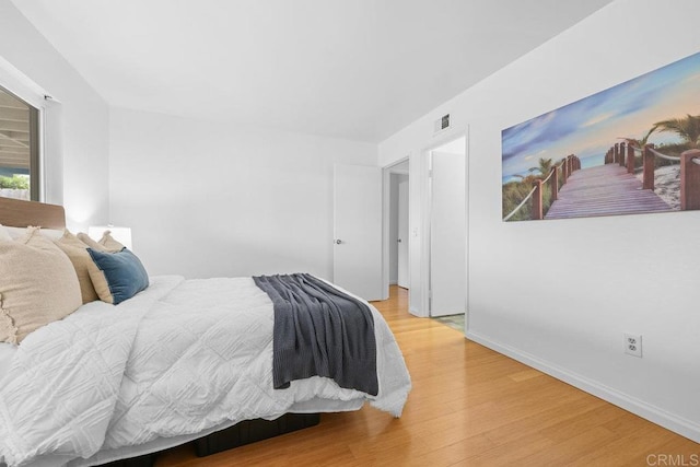 bedroom with hardwood / wood-style floors