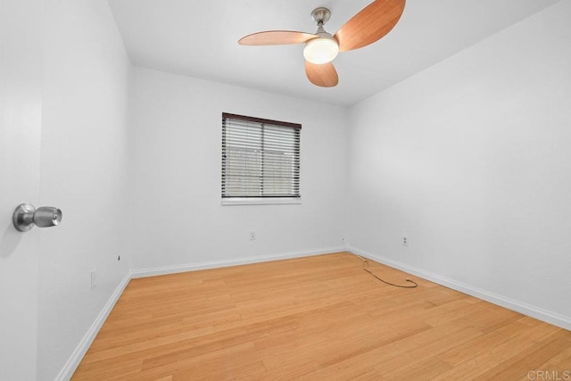 spare room with hardwood / wood-style floors and ceiling fan