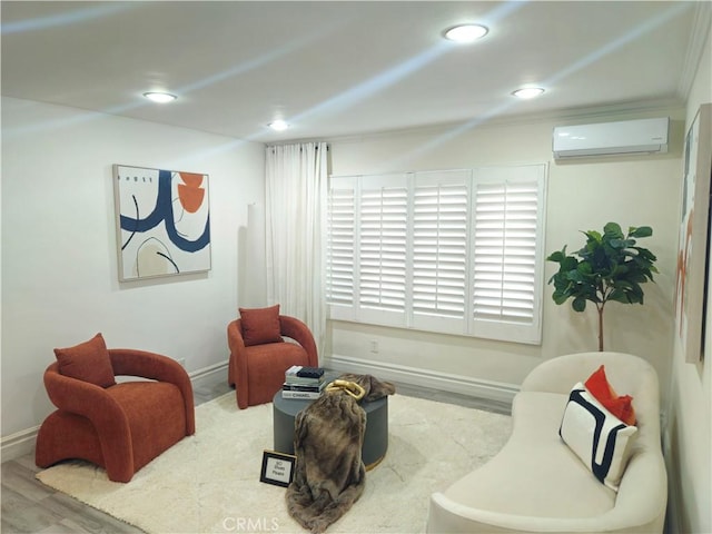 living area featuring hardwood / wood-style flooring and a wall mounted air conditioner