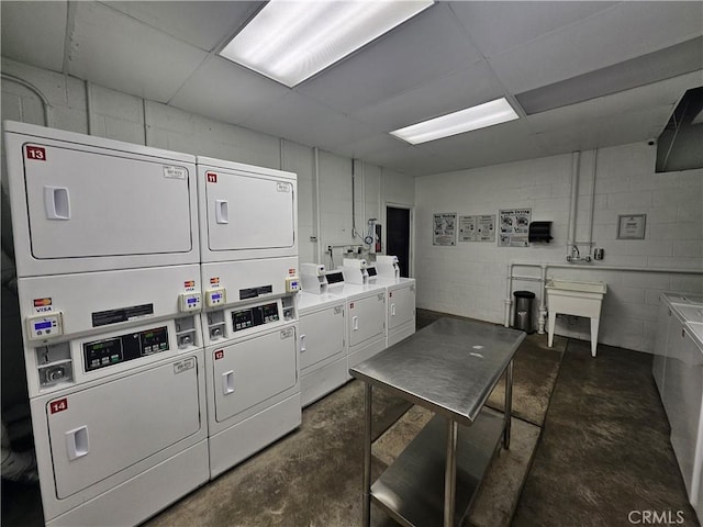 laundry area featuring stacked washing maching and dryer and separate washer and dryer