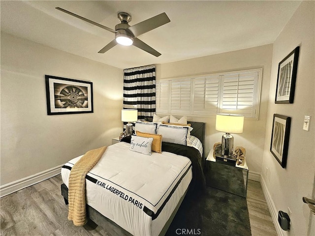 bedroom with hardwood / wood-style flooring and ceiling fan