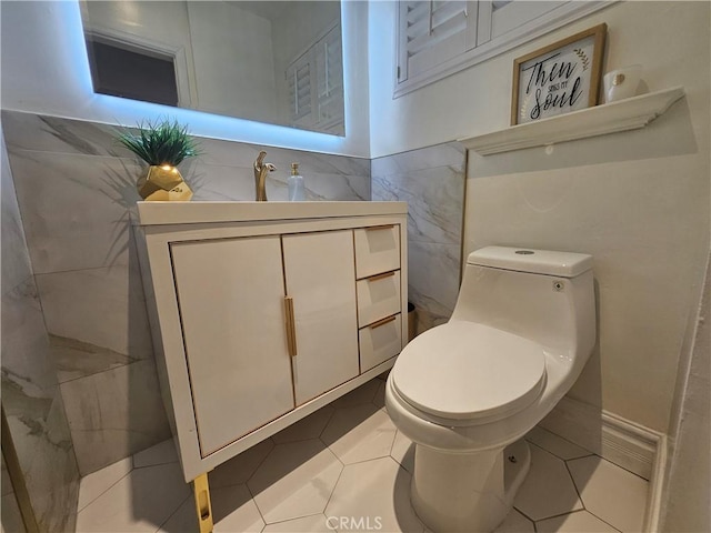 bathroom featuring vanity, tile walls, tile patterned floors, and toilet