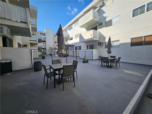 view of patio / terrace featuring an AC wall unit