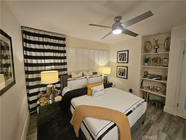 bedroom with dark hardwood / wood-style floors and ceiling fan