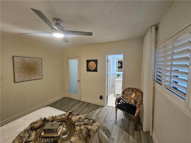 interior space with ceiling fan, connected bathroom, and dark hardwood / wood-style floors