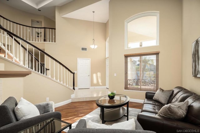 living room with a high ceiling and hardwood / wood-style floors