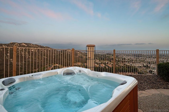 patio terrace at dusk with a hot tub