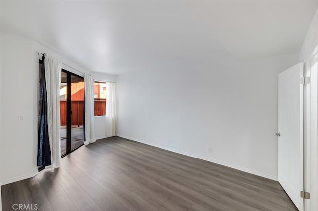 spare room featuring dark hardwood / wood-style flooring