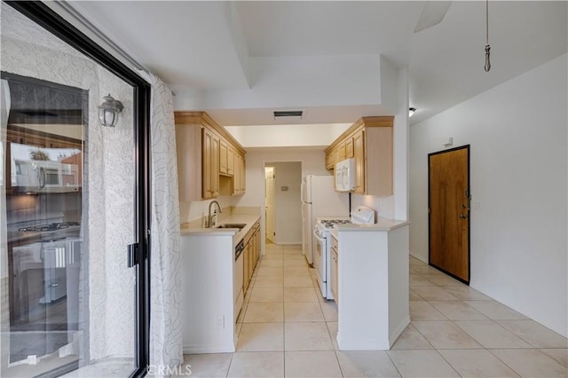 kitchen with white appliances, sink, light tile patterned floors, and light brown cabinets