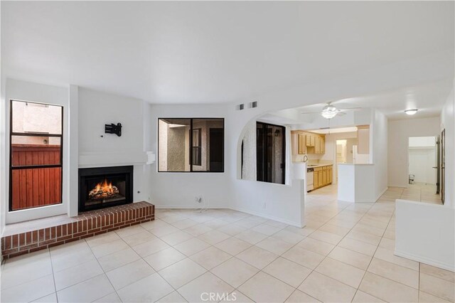 unfurnished living room featuring ceiling fan and light tile patterned floors