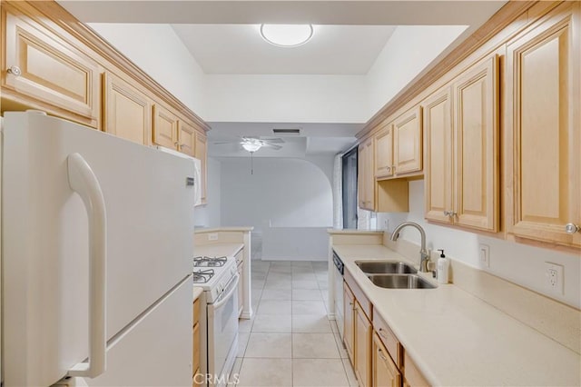 kitchen featuring sink, white appliances, light tile patterned floors, ceiling fan, and light brown cabinets