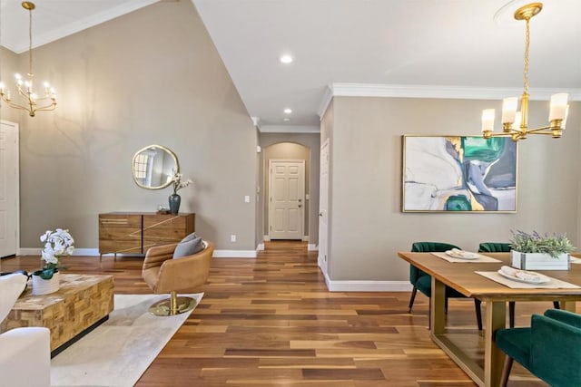 interior space with wood-type flooring, ornamental molding, and a chandelier