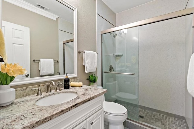 bathroom featuring vanity, toilet, and a shower with door