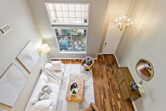 living room with hardwood / wood-style flooring and a chandelier