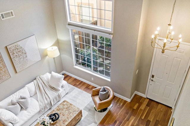 living room featuring dark hardwood / wood-style flooring and a chandelier