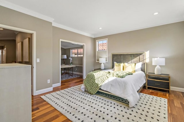 bedroom featuring crown molding, ensuite bath, and hardwood / wood-style floors