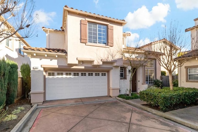 mediterranean / spanish house with a garage